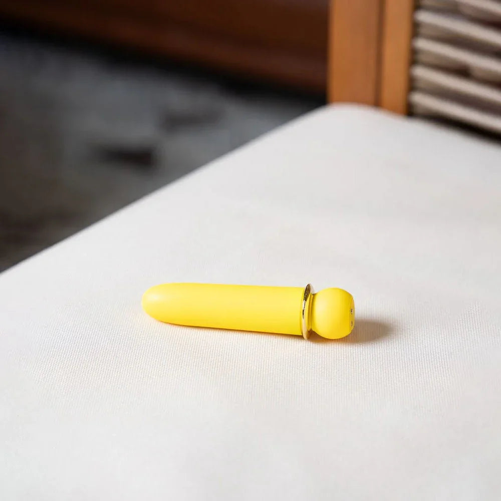 Maia Jaguar bullet in Yellow lying on a white bench top, room in soft focus behind