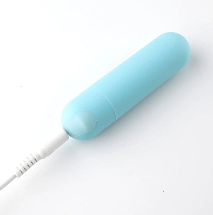 Maia Jayden blue bullet on charge, USB cable plugged into the base