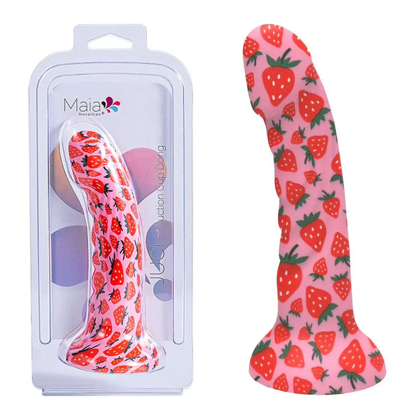 Maia Juci suction dildo in Pink with a strawberry print, beside its Maia blister pack