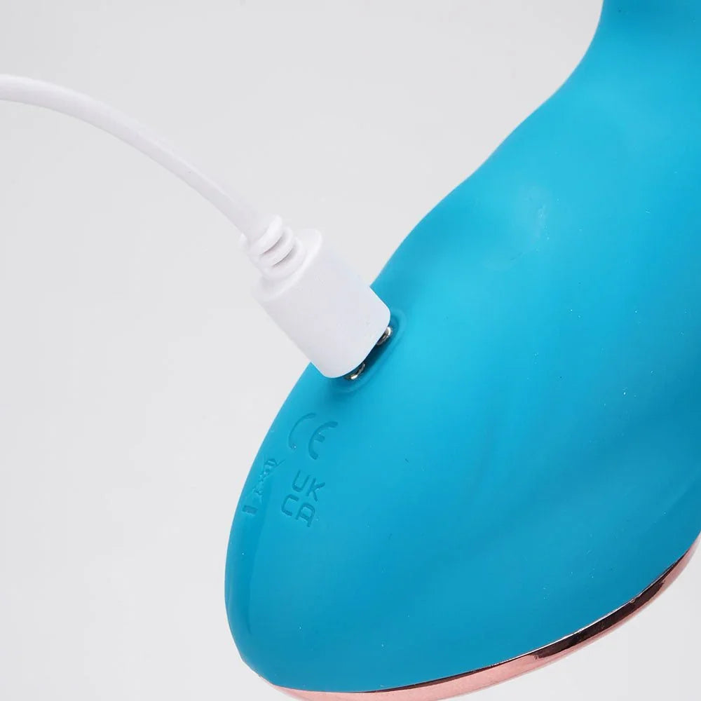 Maia Kennedi vibrator in Blue, close-up of the base with the charging cable attached