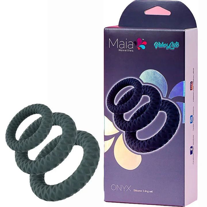 Maia Onyx cock ring set in Grey, three textured rings beside the purple Maia box