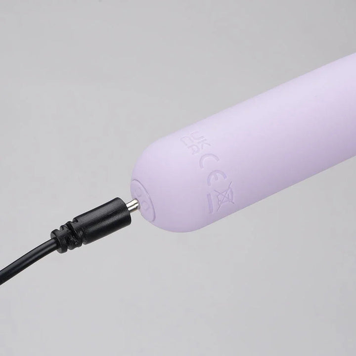 Maia Tawni bullet in Lavender on charge, cable plugged into the base