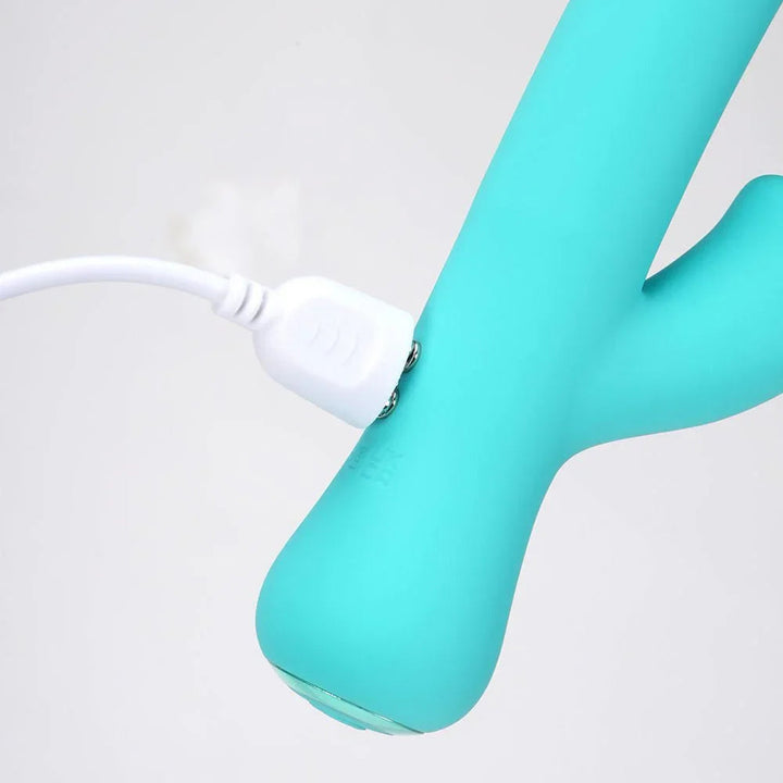 Maia Zara vibrator in Teal, close-up of the base with the charging cable attached