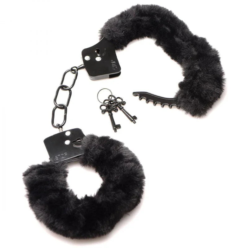 Black furry handcuffs flat on white with the keys and the black release pick beside them