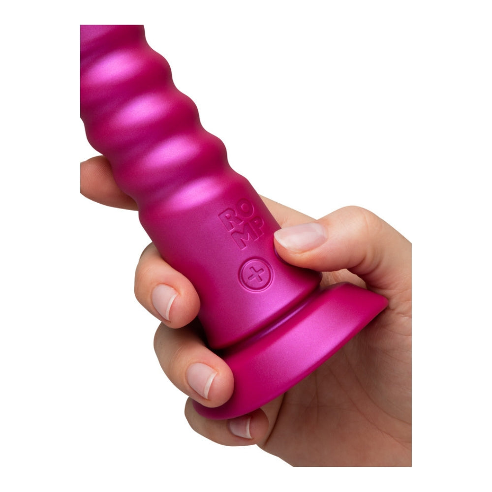 Fingers pressing the control buttons at the base of the Romp Jiggle
