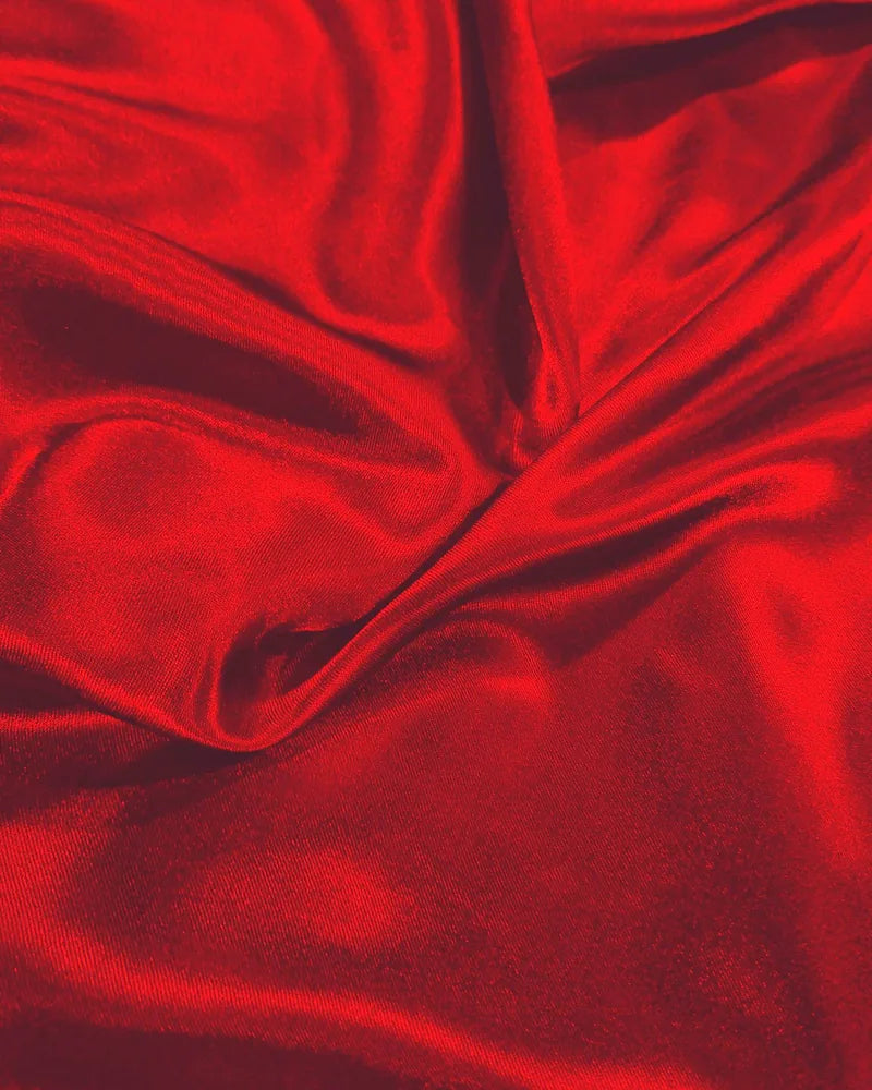 Folds of glossy red satin catching the light