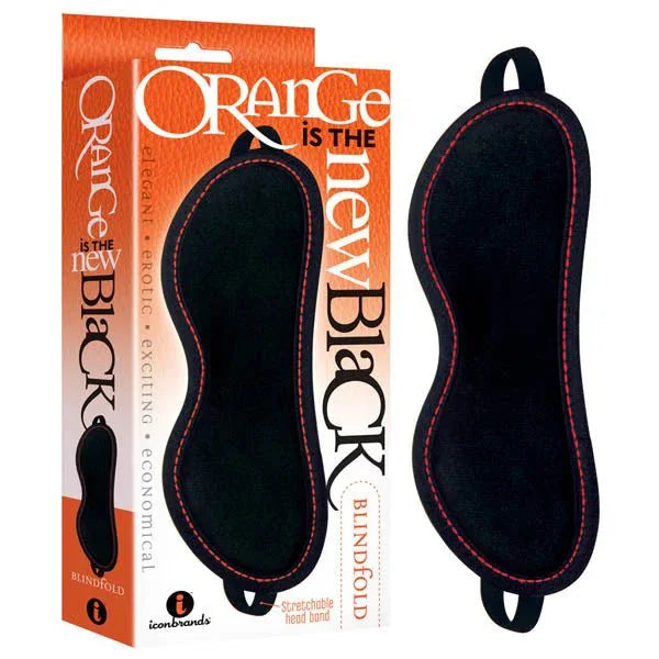 Orange Is The New Black blindfold, black padded mask with orange stitching, beside its box