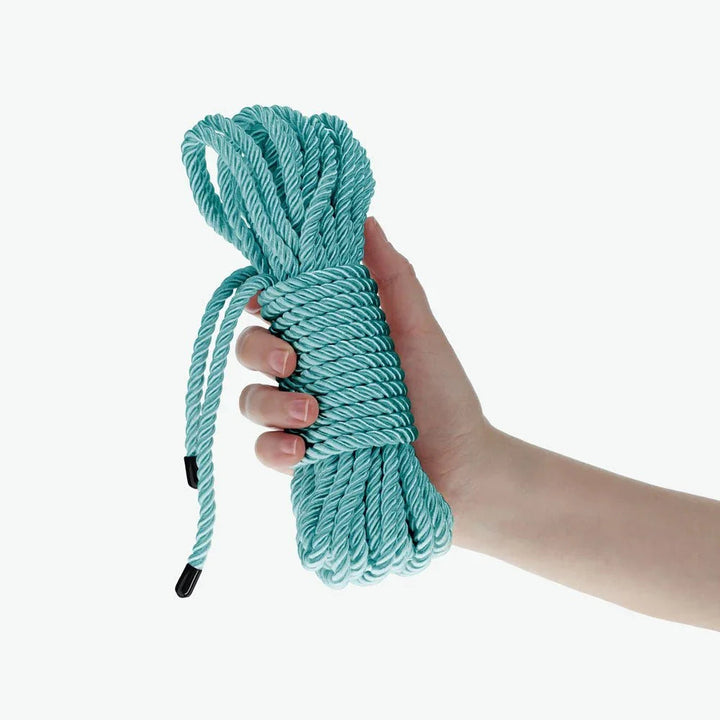 OUCH! Nylon Bondage Rope 10m in Blue, the coiled aqua hank held in one hand