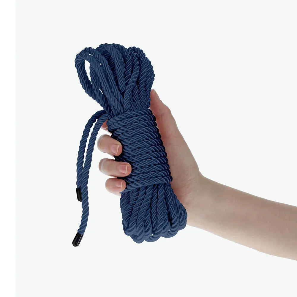 OUCH! Nylon Bondage Rope 10m in Navy Blue, the coiled navy hank held in one hand