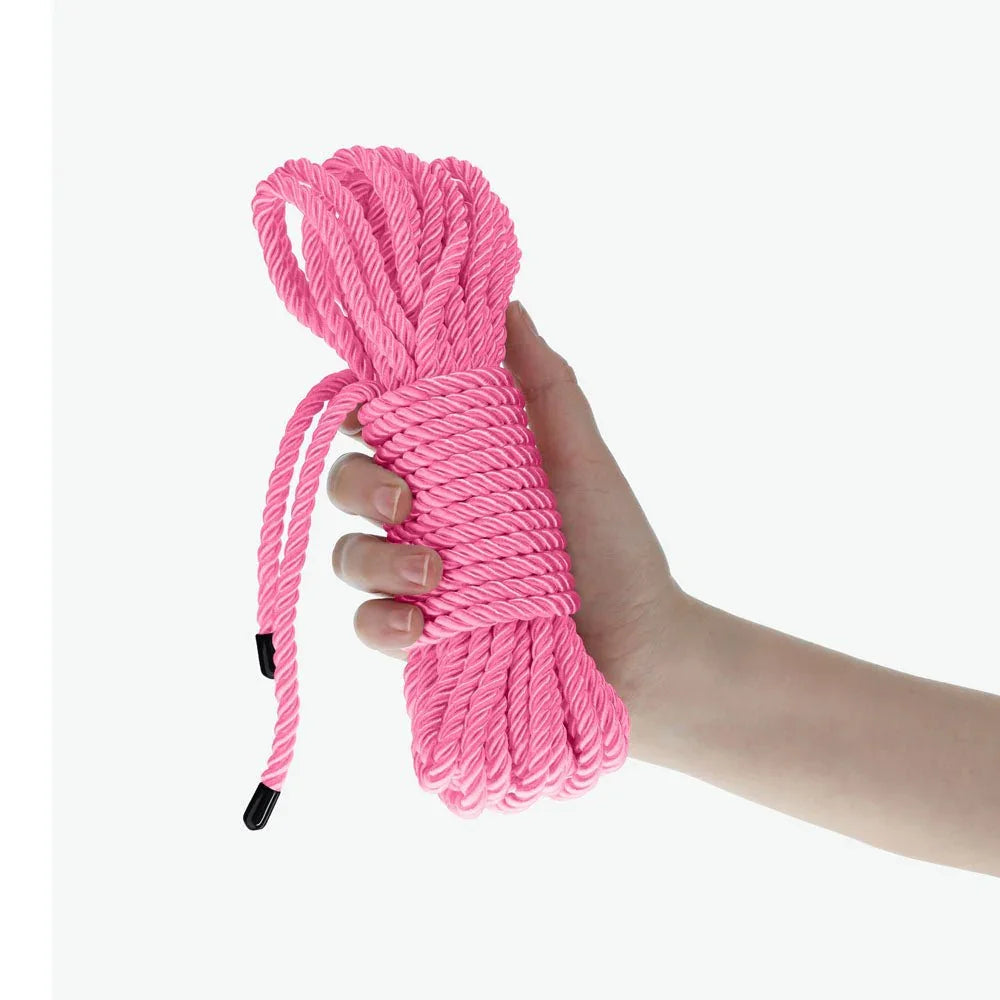 OUCH! Nylon Bondage Rope 10m in Pink, the coiled pink hank held in one hand