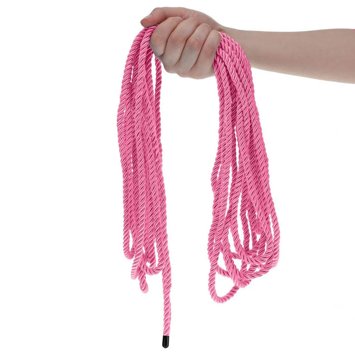 OUCH! Nylon Bondage Rope 10m in Pink, held up with the pink loops hanging free against white