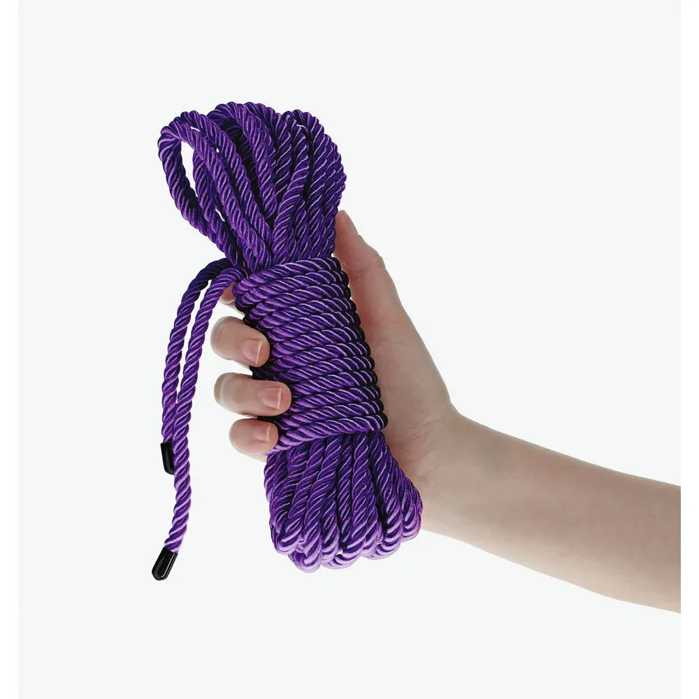 OUCH! Nylon Bondage Rope 10m in Purple, the coiled purple hank held in one hand