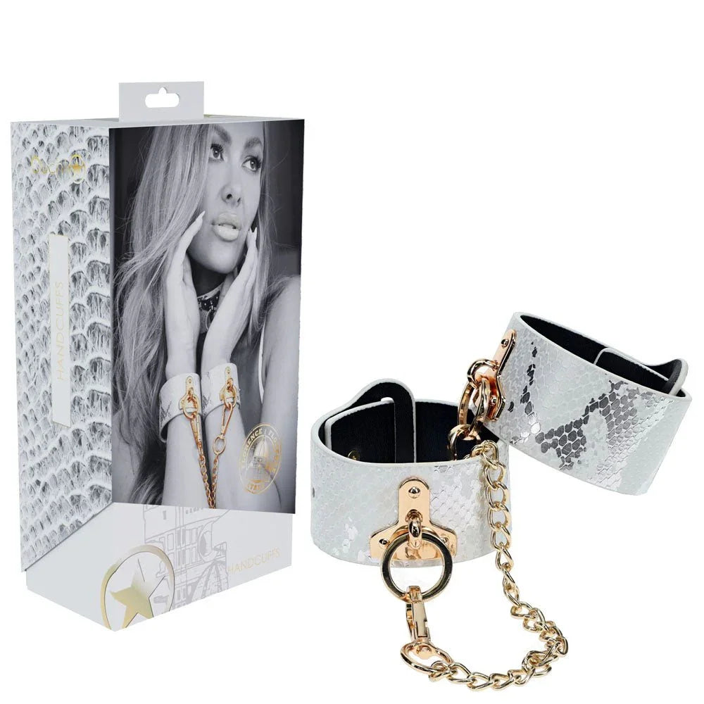 OUCH! Florence Handcuff Restraints in White, retail box beside the snake-print cuffs and gold chain