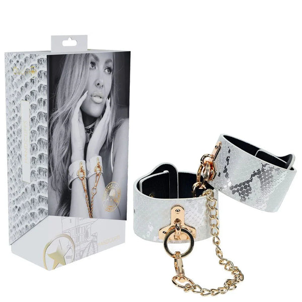 OUCH! Florence Handcuff Restraints in White, retail box beside the snake-print cuffs and gold chain