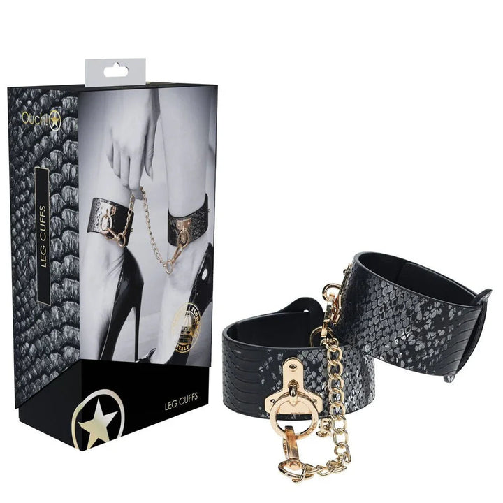 OUCH! Florence Leg Cuff Restraints in Black, black box beside the dark snake-print leg cuffs