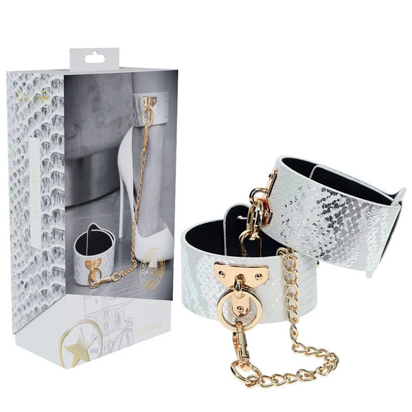 OUCH! Florence Leg Cuff Restraints in White, retail box beside the white snake-print leg cuffs