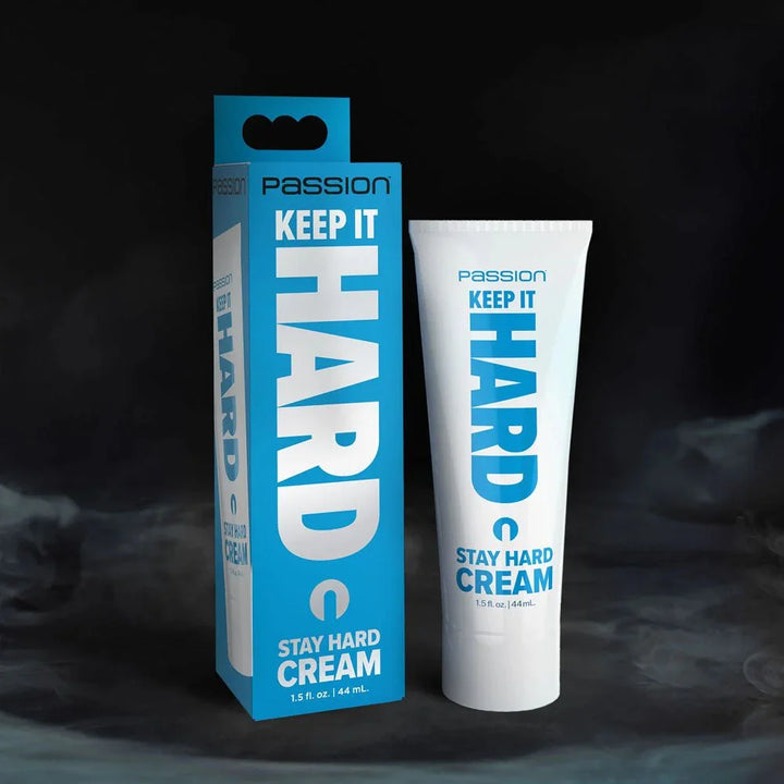 Passion Keep It Hard stay hard cream, white tube beside its blue carton on a dark backdrop
