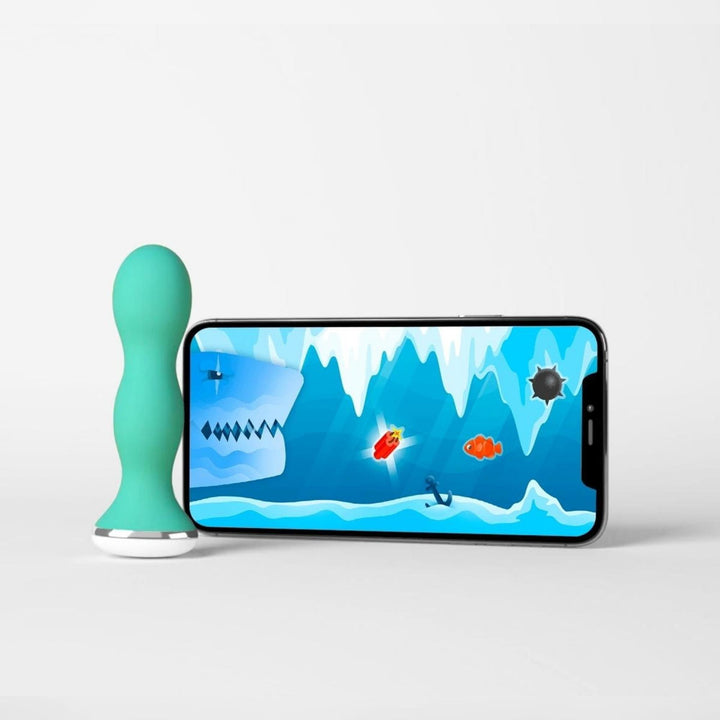 Green Perifit Care standing next to a phone playing an underwater Perifit training game