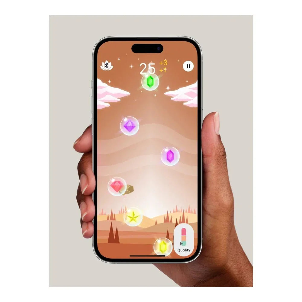 Hand holding a phone running the Perifit gem-collecting training game