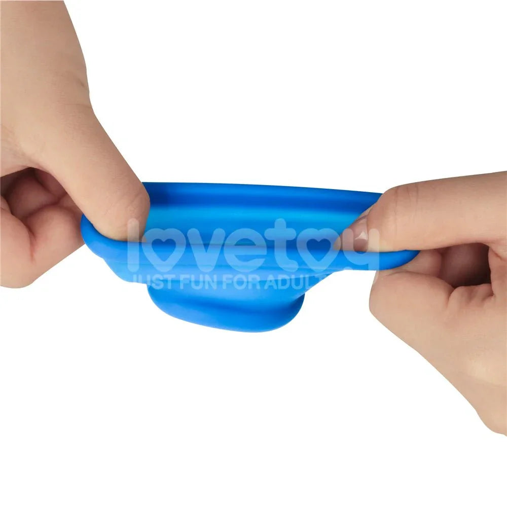 Two hands pulling the blue Tapered Squeeze stretcher wide to show the stretch