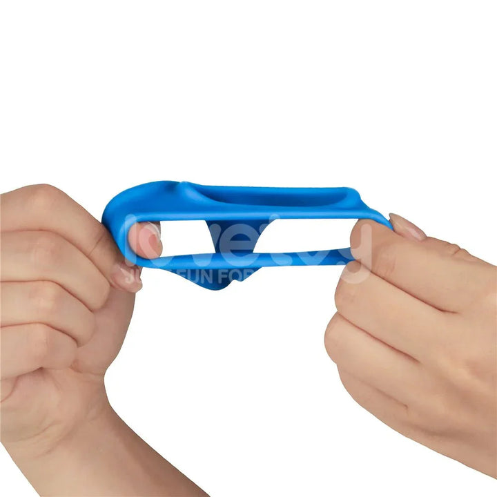 Two hands stretching the blue Trio Grip Enhancer wide between the fingers