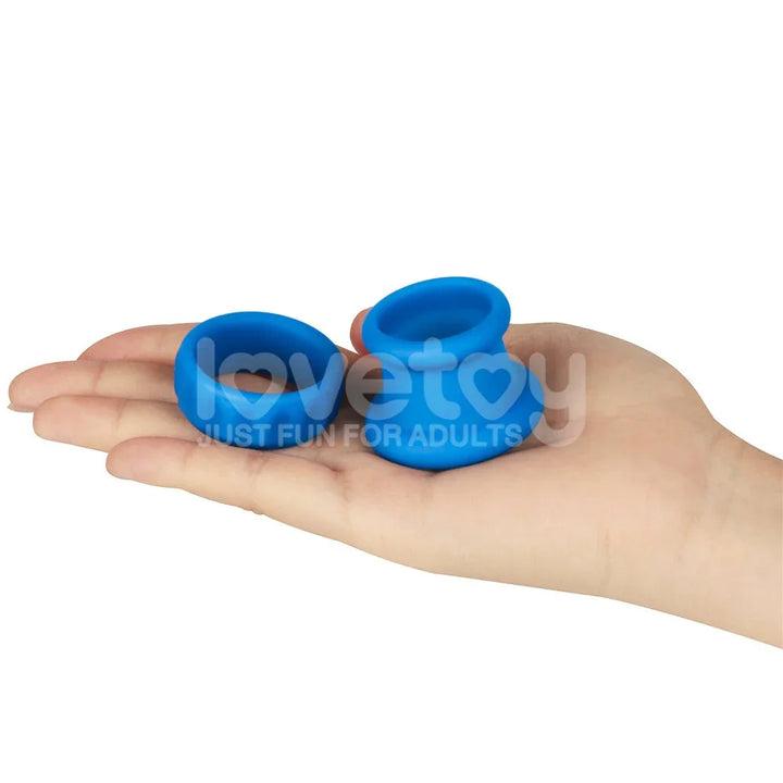 Both blue Twin Flex rings resting on an open palm to show their size