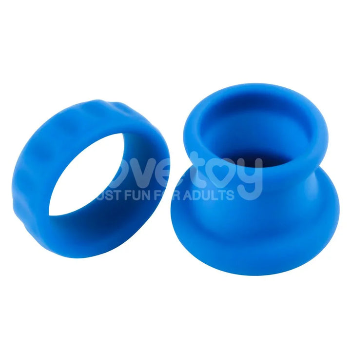 Blue Twin Flex pieces side by side, the flat cock ring next to the taller stretcher