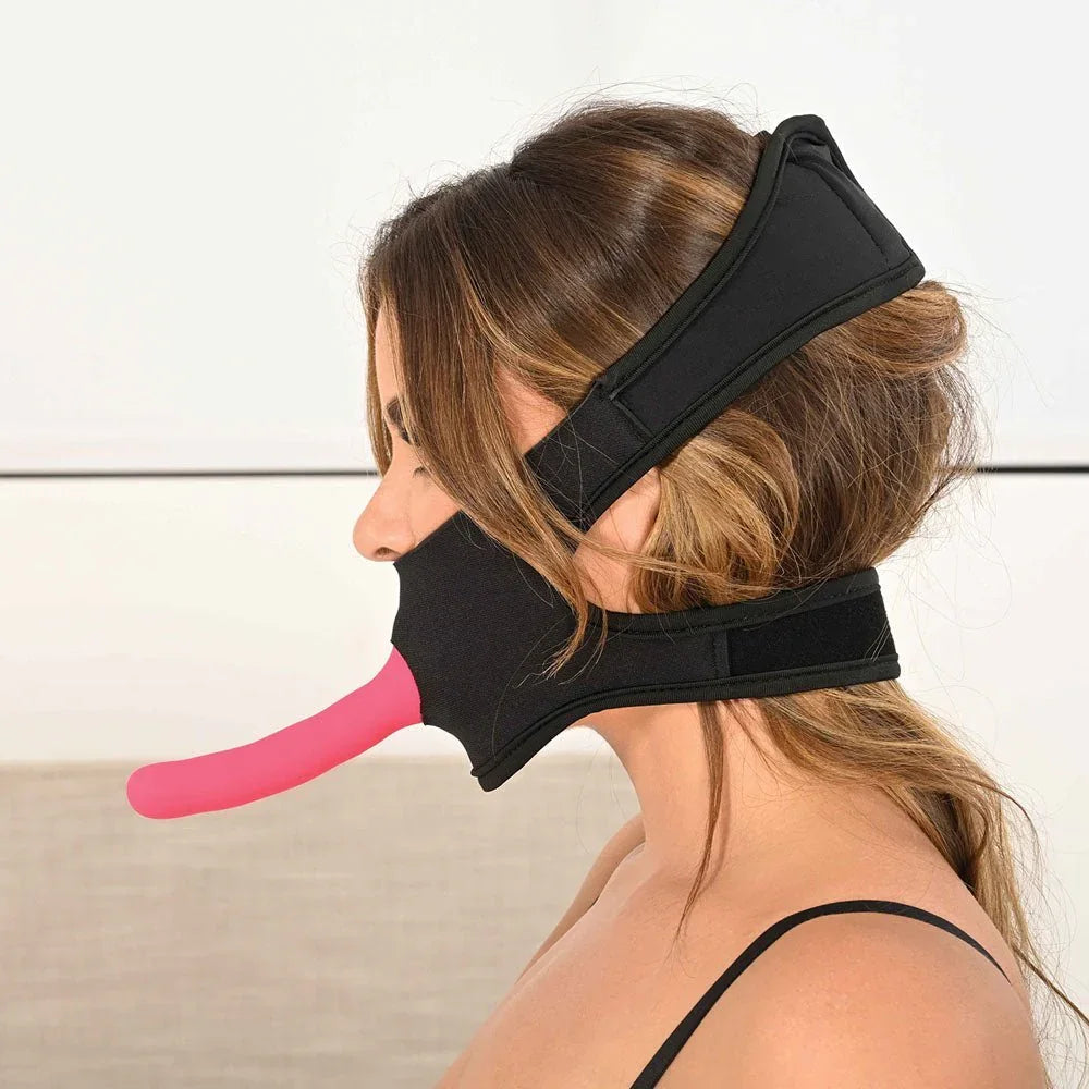 Side profile of the face harness worn, pink probe projecting from the mouth panel
