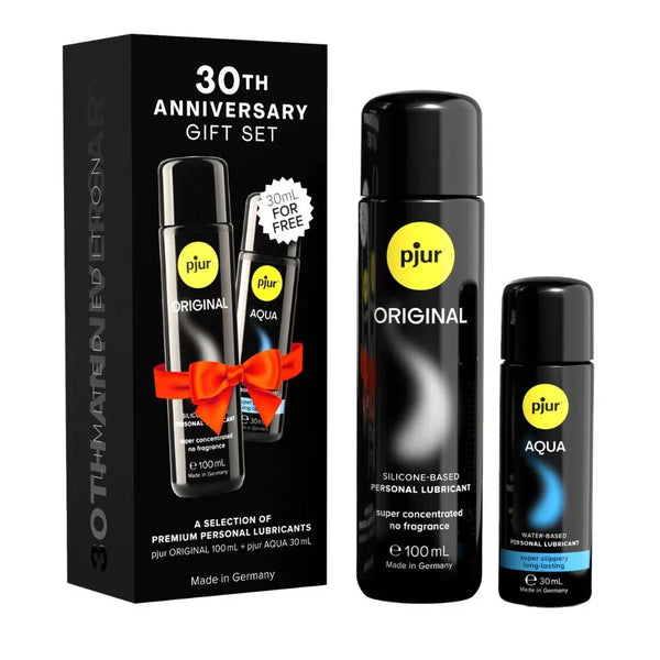 pjur 30th Anniversary Gift Set, black box with red bow beside Original 100 ml and Aqua 30 ml bottles
