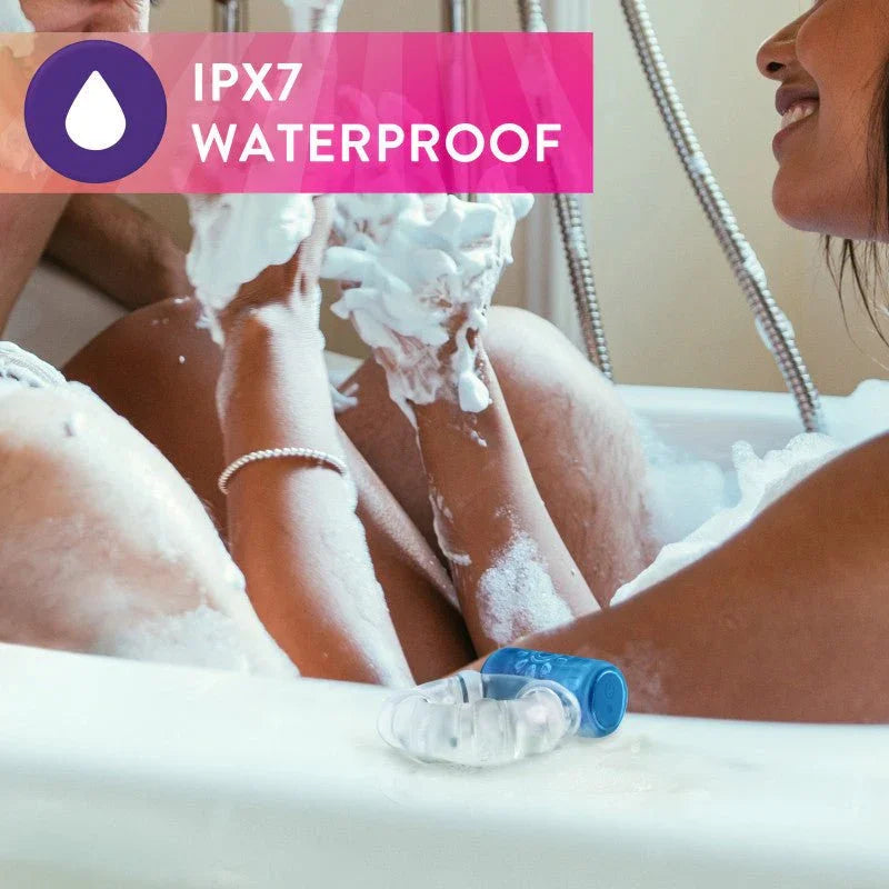 Blue Pleaser C-ring resting on a bath edge amid bubbles, IPX7 waterproof panel