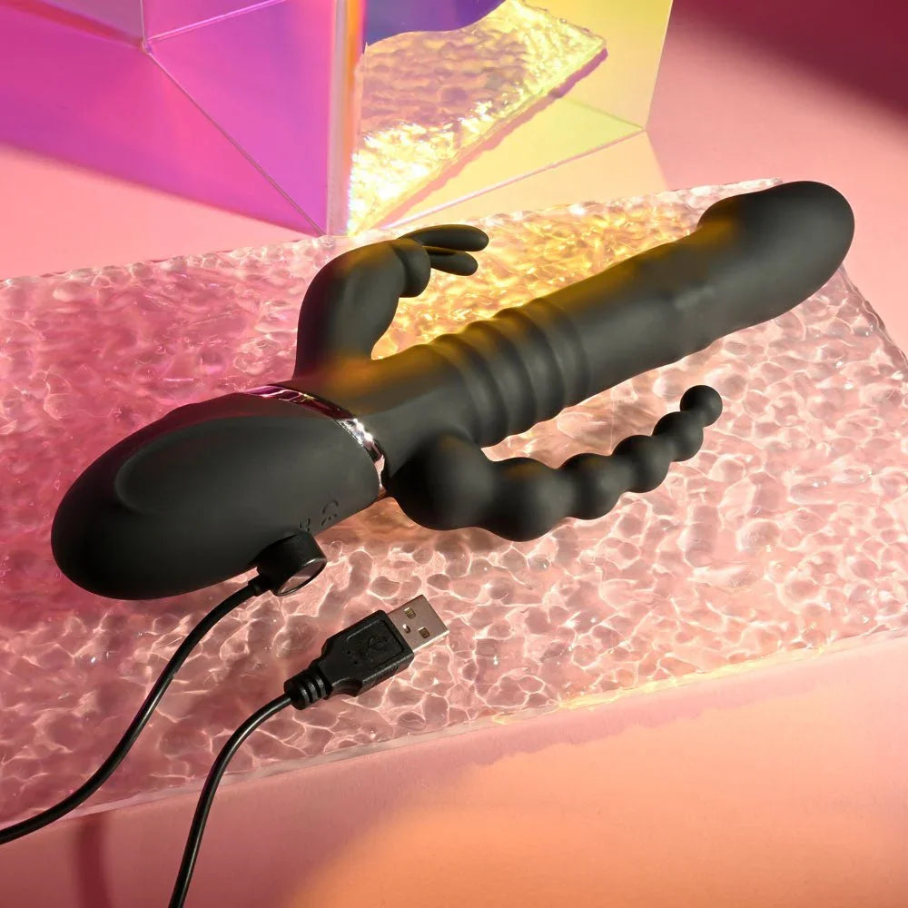 Black Big Bunny Energy with its USB charging cable plugged into the base