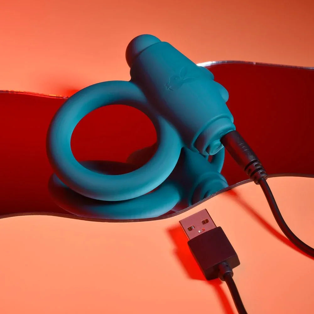 Green Bunny Buzzer cock ring with the USB charging cable plugged into the bullet