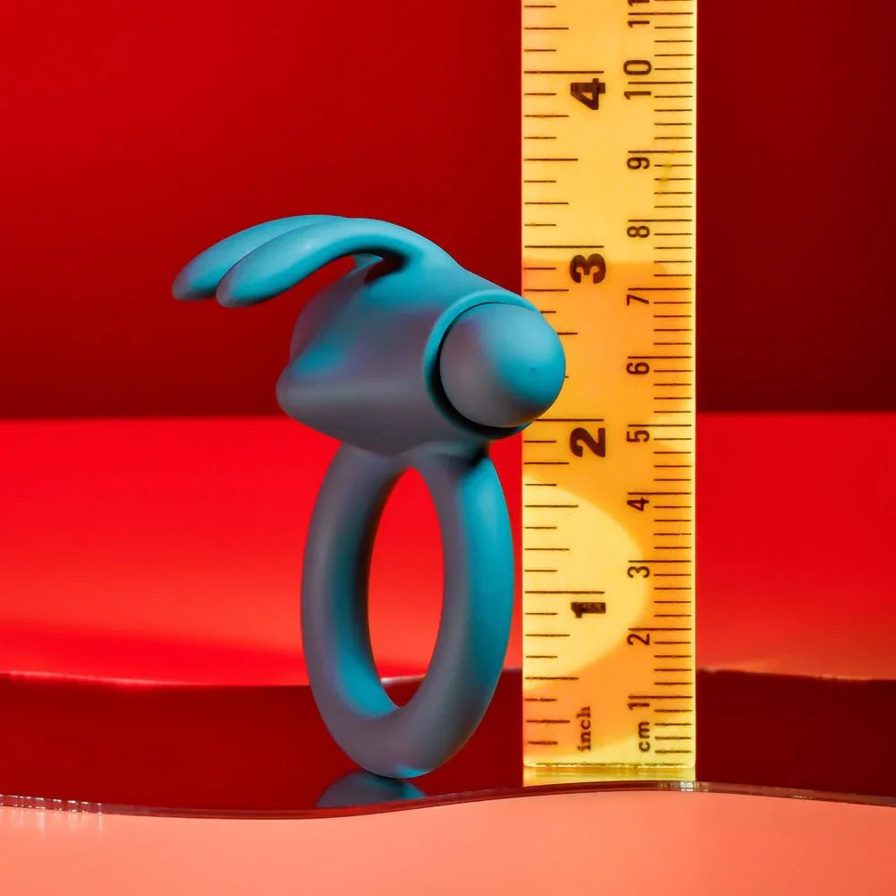 Green Bunny Buzzer cock ring beside a ruler, the loop about 2 inches across