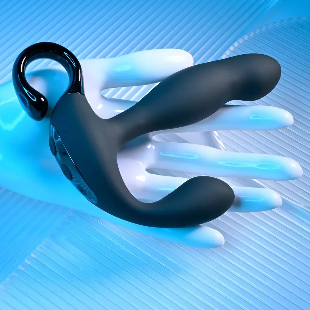 Come Hither prostate massager laid over a white display hand under blue light