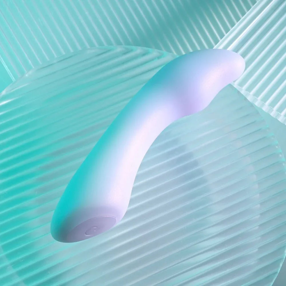 Opal Euphoria mini vibrator lying on ribbed glass, gentle upward curve