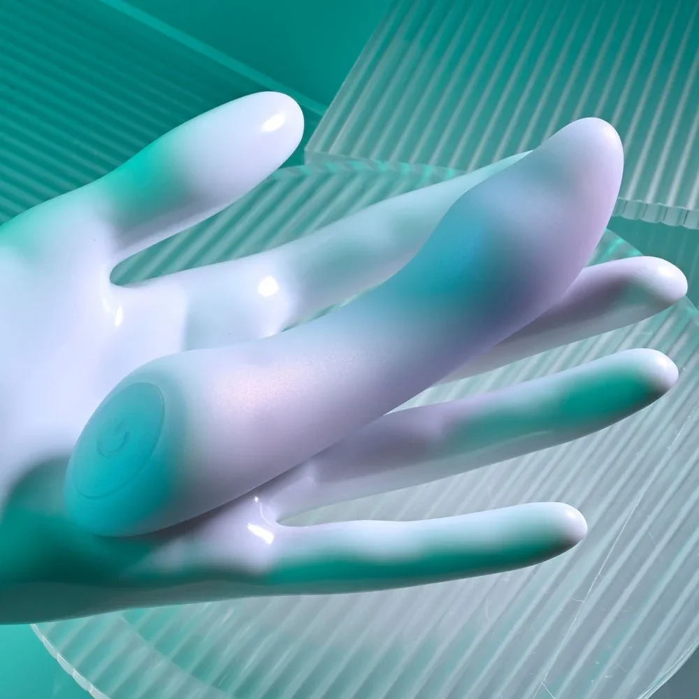 Opal Euphoria vibrator balanced on a white display hand against ribbed glass