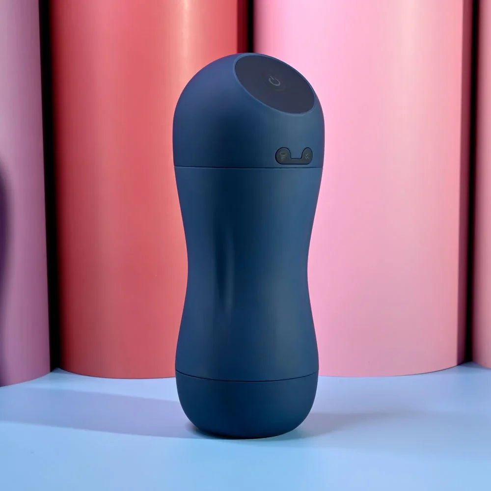 Navy Gusto masturbator standing capped against a pink and blue backdrop
