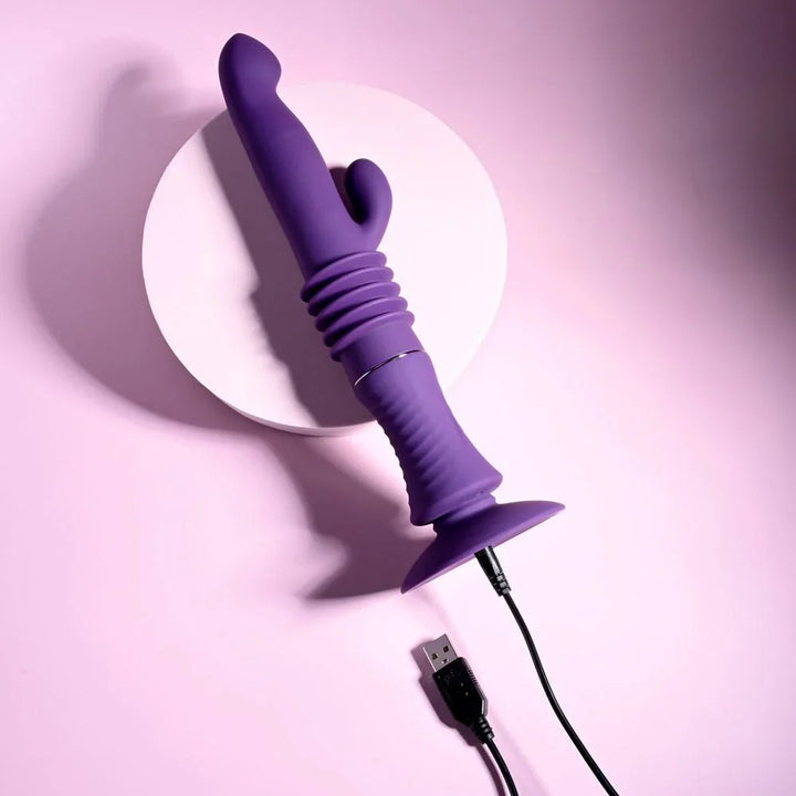 Purple Hoppy Ending laid on the diagonal with its USB charging cable plugged in