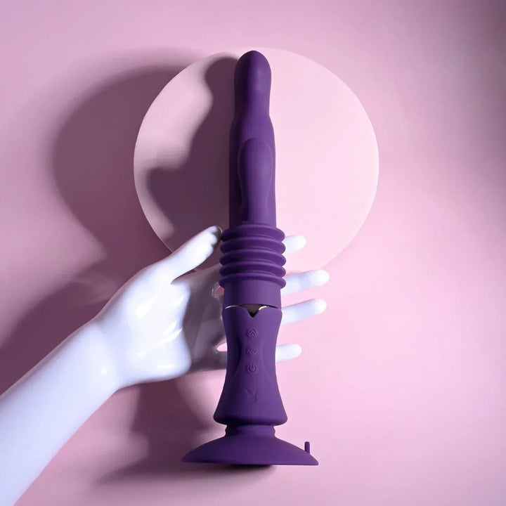 A white display hand resting on the upright purple Hoppy Ending rabbit vibrator