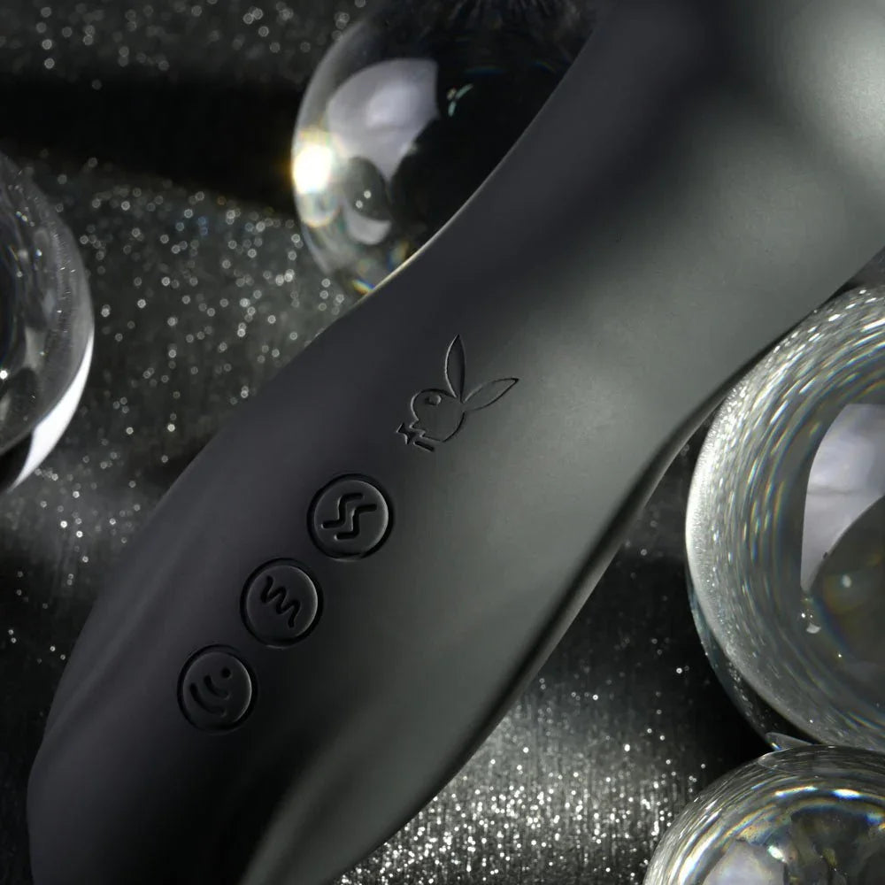Close-up of the Let It Bead control buttons and Playboy bunny on black silicone