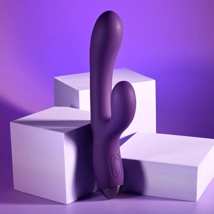 Purple New Crush rabbit vibrator standing upright against white blocks