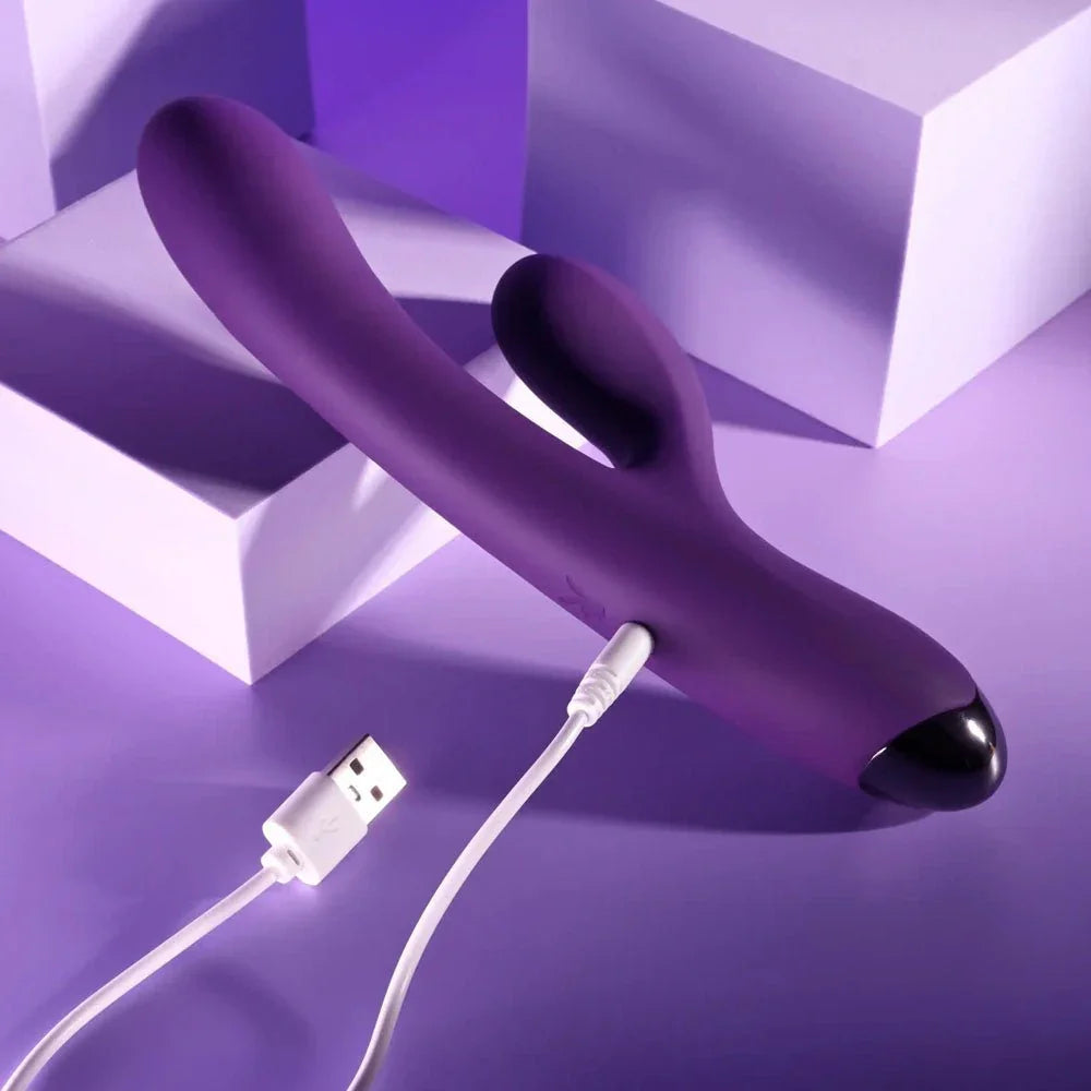Purple New Crush with its white USB charging cable plugged into the base