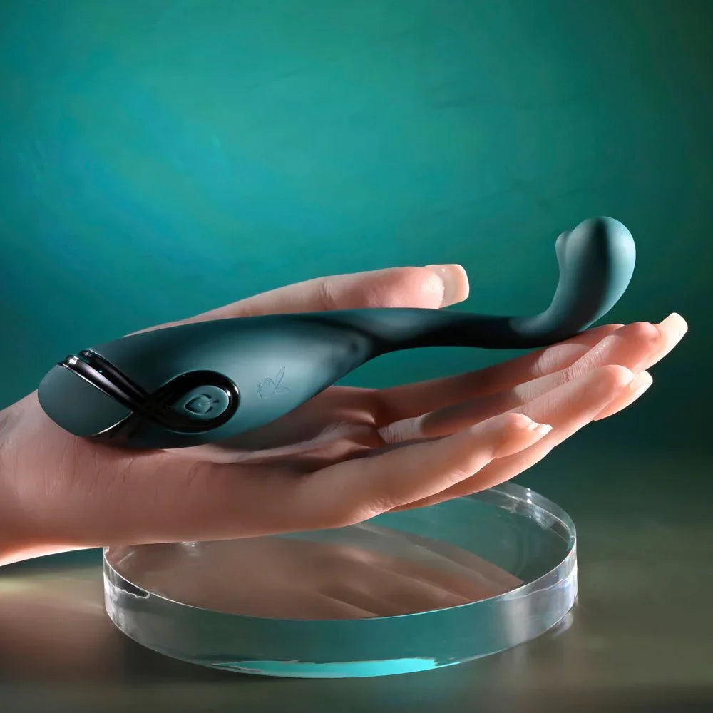 Pinpoint Perfection vibrator in green balanced on a hand for scale