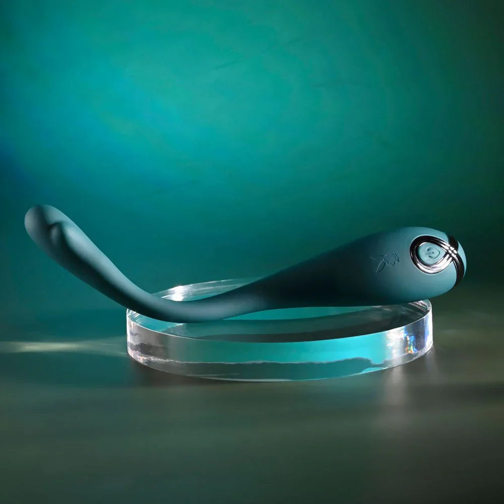 Green Pinpoint Perfection lying on a glass disc with the slim tail curving away