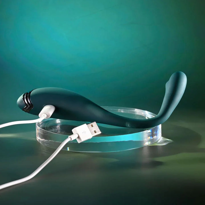 Green Pinpoint Perfection with its white USB charging cable plugged into the base
