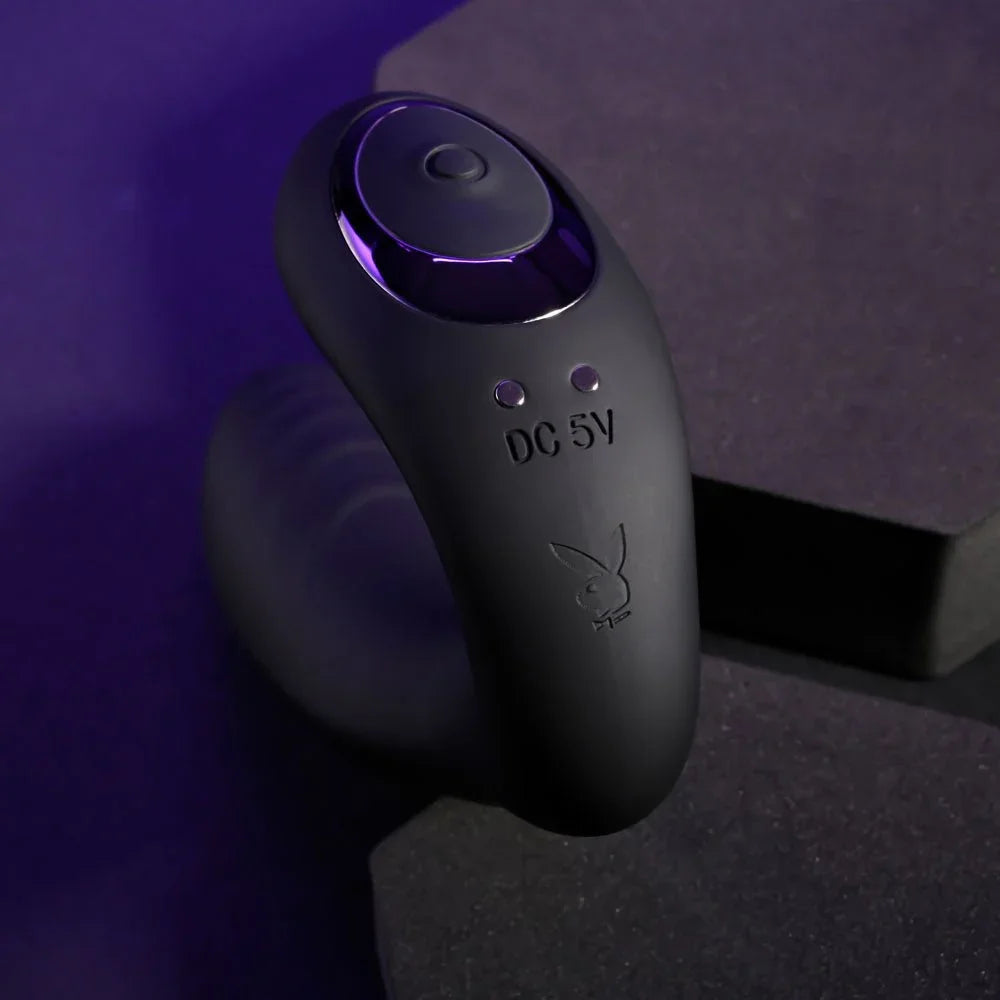 Close-up of the Play Time control button and Playboy bunny on black silicone