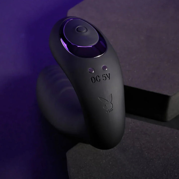 Close-up of the Play Time control button and Playboy bunny on black silicone