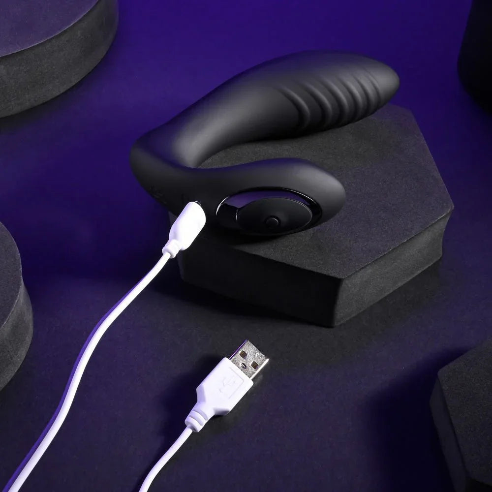 Black Play Time vibrator with its white USB charging cable connected