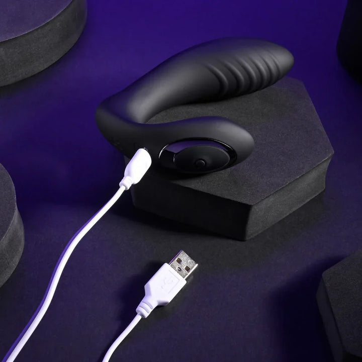 Black Play Time vibrator with its white USB charging cable connected