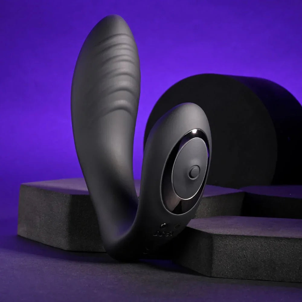Black Play Time vibrator standing upright, ribbed arm and round control in view